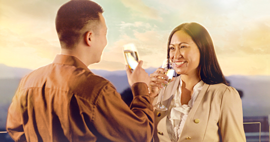 Man and women drinking wine outside